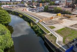 An aerial view of the completed riverside walkway in Rotherham links Water Lane to the town centre, supported by new sheet piling and concrete capping beams.