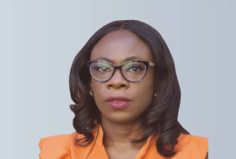 A head and shoulders picture of Ola Obadara FCIOB will serve as CIOB Vice President for 2025/26, the first black woman to hold the role, wearing an orange top and glasses with shoulder length hair