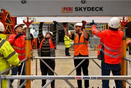 A group of PPE glad people receive formwork training from PERI UK, which delivers hands-on, accredited formwork training at its Brentwood facility and nationwide.