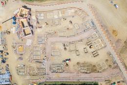 A drone shot of a new housing estate under construction showing the foundations of the new houses