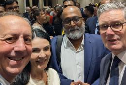 Four people look into the camera to take a selfie