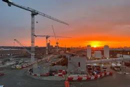 Sunrise over the construction of Old Oak Common Station in London, one of several HS2 sites supplied by Holcim UK, with a tower silhouetted against a setting sun