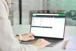 A close up of someone's hands working on a laptop