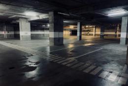 A dimly lit underground concrete carpark