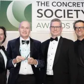 Four men holding an award