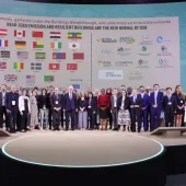 Lots of people standing on a podium with their countries flags in the background following the launch of the UAE and Canada's Breakthrough Initiative at COp28