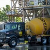 A blue and yellow concrete mixer truck