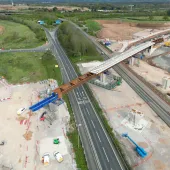 Aerial photo of a blue and brown viaduct under construction