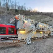 A red railway carriage entering a tunnel