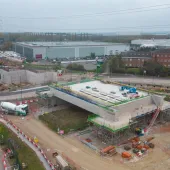 An aerial photo of an HS2 construction site showing a large concrete structure and a blue crane