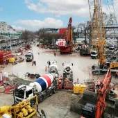 A crane, concrete mixer, excavator and other construction equipment helping pour concrete for the Austerlitz Basin in Paris