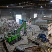 Inside SUEZ's recycling facility at Malpass Farm in Rugby, where Climafuel is produced in order to heat the kiln at Cemex's Rugby cement plant, a green material handler sorts waste