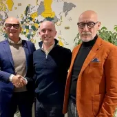 Left to right: Marco Scuratti, IMER Group; Will Harris, Utranazz; Michele Sebastiani, IMER Group shake hands on the new distribution deal between the two companies.
