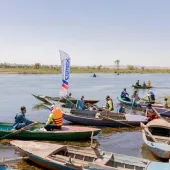 People in small boats help clear the River Nile as part of the VeryNile environmental initiative