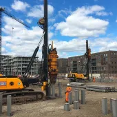 A yellow piling rig installing Precast Concrete Piles