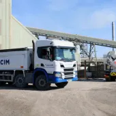 A white, Holcim branded truck at a cement works.