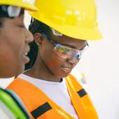 Two women in PPE.