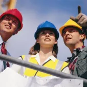 Three people in PPE. One in a red hard hat, one in blue and one in yellow.