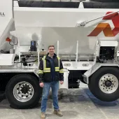 Derrick Murias, the new General Manager at ProAll, stand in front of a ProAll mixer.