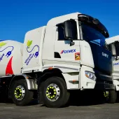 Two of Cemex's new electric trucks, which are designed for urban use, offering up to a 100% reduction in CO₂ emissions when powered by renewable energy and operate at significantly lower noise levels than traditional diesel-powered vehicles.