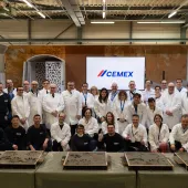 A group of people in white lab coats outside Cemex's GRD.