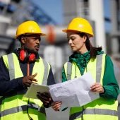 Construction workers in PPE talking