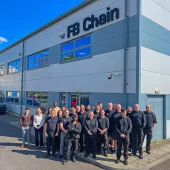FB Chain employees celebrate 40 years of conveyor chain manufacture and innovation outside the company's factory.