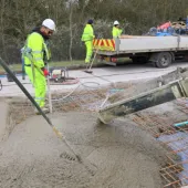 Men in PPE carry out repairs to the concrete road section of the M54
