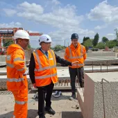 Three men in PPE, including Councillor Tony Eaton, chairman of Bassetlaw District Council, examine precast concrete elements in ABM Precast Solutions' yard during the company's 20th Anniversay celebrations.