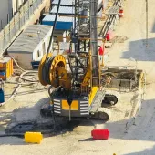A view of a yellow Bauer piling rig at work on Cairo, Egypt's new metro station in Giza. In an estimated 14 months, Bauer Egypt will execute 209 diaphragm wall panels and 20 barrettes for Cairo's new metro station in the Giza district. Despite limited space and other challenges, work is progressing smoothly. Image: BAUER Group