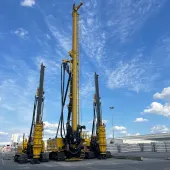 Three yellow piling rigs on a hard stand at RBL.