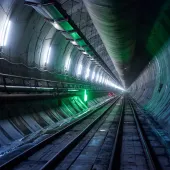 A diimly lit, concrete lined tunnel, Part of the newly completed westbound tunnel on the Italian side of the Brenner Base Tunnel. Over 400,000 precast segments will be used in total. (Image: Webuild)