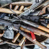 A bag of old hand tools with wooden handles