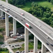 Workers monitor the precise hydraulic shift of the 40,000-tonne Rinsdorf viaduct, moved laterally into position in a German engineering first.