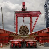 The large, red TBM Emily’s cutterhead lifted at Green Park Way shaft following completion of Northolt Tunnel section