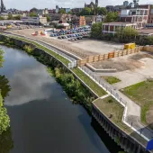 An aerial view of the completed riverside walkway in Rotherham links Water Lane to the town centre, supported by new sheet piling and concrete capping beams.