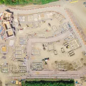 A drone shot of a new housing estate under construction showing the foundations of the new houses
