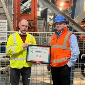 Chris Jones (right) of Mona Precast with David Wyke (left) of KVM, marking 25 years of block production at the Anglesey site.