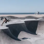 2024/25 Concrete in Life Winner, Venice Beach Skating by Henrik Hagerup shows a single skateboarder performing tricks at a concrete skatepark with the sea and beach in the background