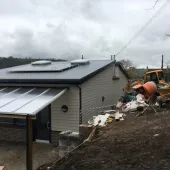 The incomplete concrete block retaining wall at Swainswick School collapsed after aggregate was placed against it.