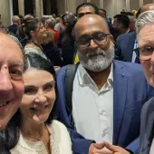 Four people look into the camera to take a selfie