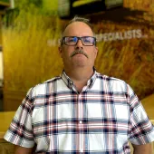 Kris Hand in checked shirt, glasses and a moustache, rejoins Roger Bullivant’s South Central residential team as operations manager, focusing on standardising practice, safety and skills development.
