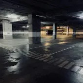 A dimly lit underground concrete carpark