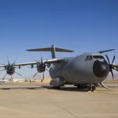 a large, four prop plane on a runway