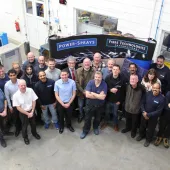 A group of workers in a factory photographed from above