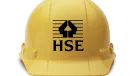 A yellow hard hat with the HSE logo in black on its front