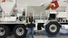 Derrick Murias, the new General Manager at ProAll, stand in front of a ProAll mixer.