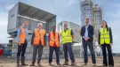 L–R: Prof. David Hughes; Bob Borthwick; Scott Bros recycling innovation engineer Feysal Shifa; Peter Scott; Joss Newberry; and Cassidy Smith, Teesside University’s IP and commercialization manager, standing in front of Scott Brothers new low-carbon concrete plant in Teeside.