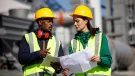 Construction workers in PPE talking