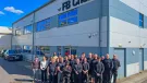 FB Chain employees celebrate 40 years of conveyor chain manufacture and innovation outside the company's factory.